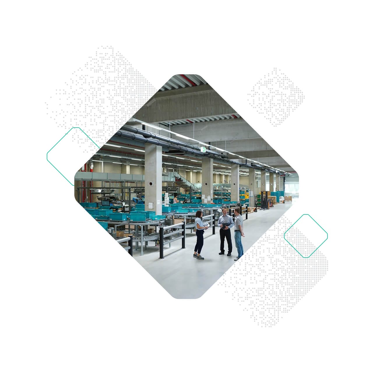 People standing and talking in a spacious industrial facility, surrounded by rows of Stauff machinery.