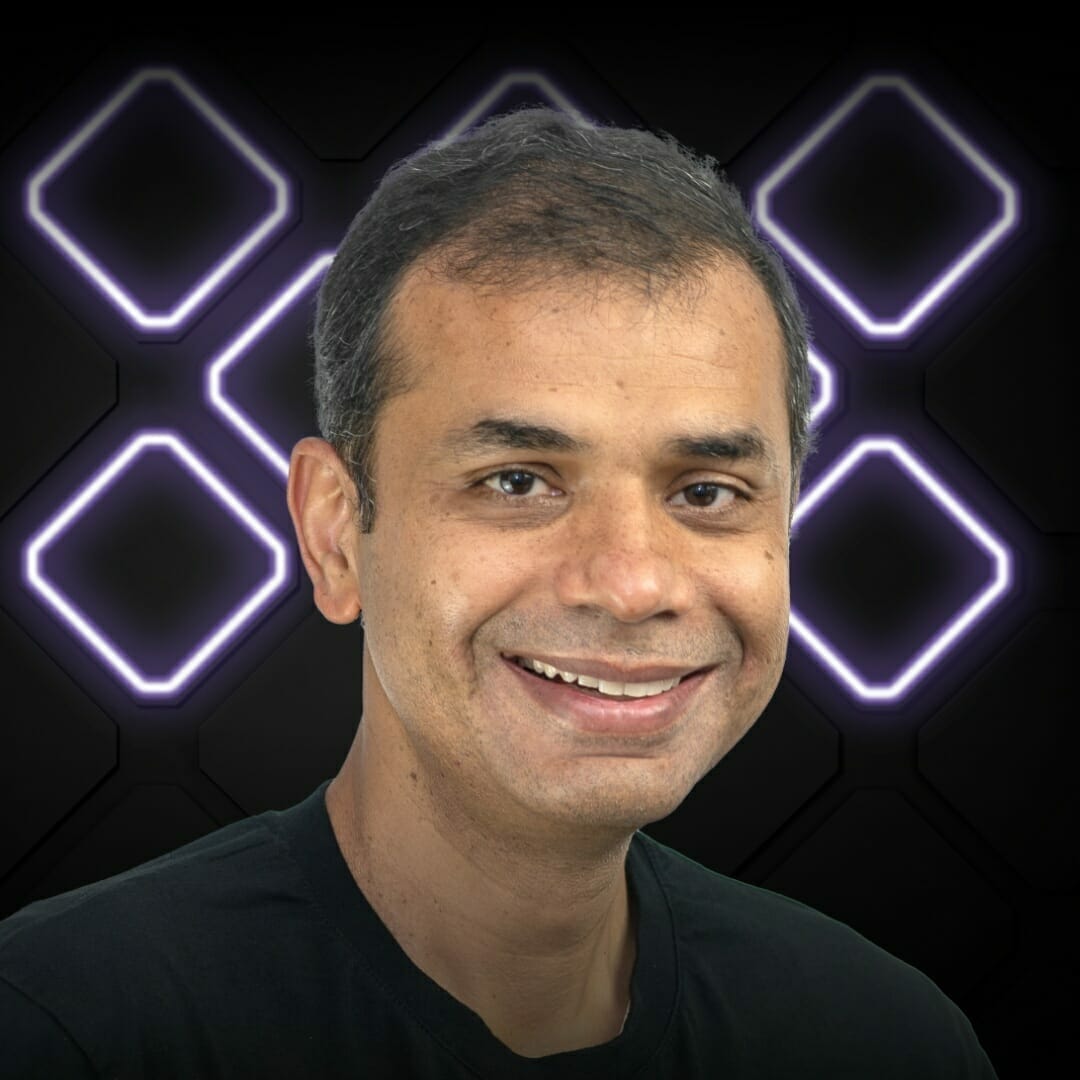 A person with a friendly smile is posing in front of a black background with glowing square patterns, capturing the exciting energy of EXCITE 2022 Nashville.