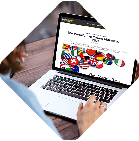 Person using a laptop displaying a webpage titled "The World’s Top Online Marketplaces 2021" with multiple international flags visible, showcasing leading B2B marketplaces around the globe.